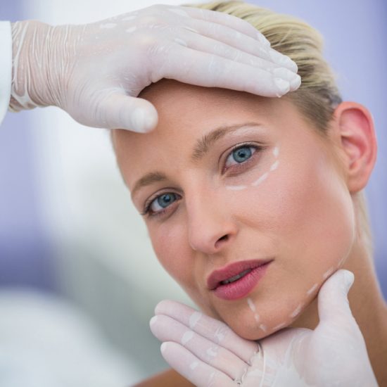 doctor-examining-female-patients-face-cosmetic-treatment